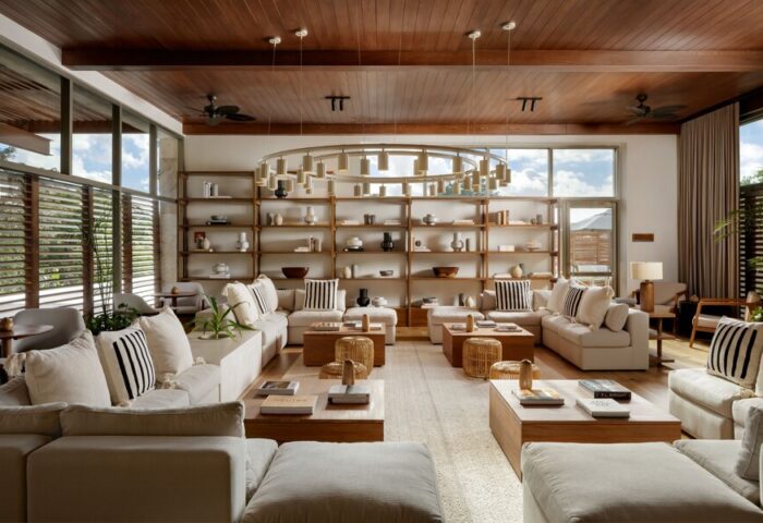 Fairmont Mayakoba, a gay-friendly hotel: stylish lounge area with couches, shelves, and a unique chandelier. Luxury travel for gay men.