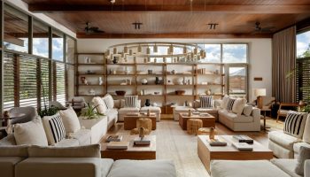 Fairmont Mayakoba, a gay-friendly hotel: stylish lounge area with couches, shelves, and a unique chandelier. Luxury travel for gay men.