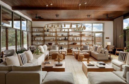 Fairmont Mayakoba, a gay-friendly hotel: stylish lounge area with couches, shelves, and a unique chandelier. Luxury travel for gay men.