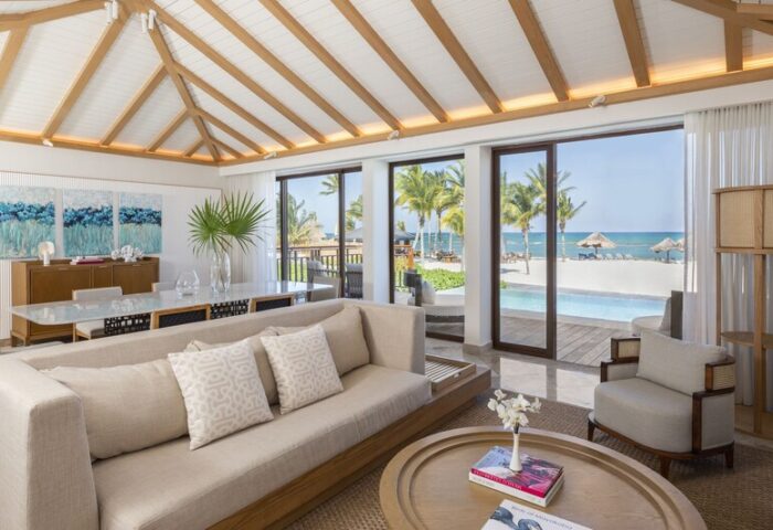 Fairmont Mayakoba gay-friendly hotel suite. Living area with ocean view, pool, and beach. Luxury travel for gay men in Riviera Maya.