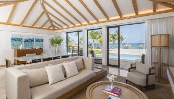 Fairmont Mayakoba gay-friendly hotel suite. Living area with ocean view, pool, and beach. Luxury travel for gay men in Riviera Maya.