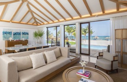 Fairmont Mayakoba gay-friendly hotel suite. Living area with ocean view, pool, and beach. Luxury travel for gay men in Riviera Maya.
