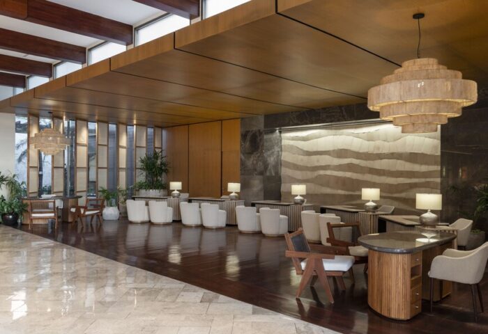 Fairmont Mayakoba, a gay-friendly hotel. Lobby with modern lighting, wood accents, and seating. A stylish choice for gay travelers.