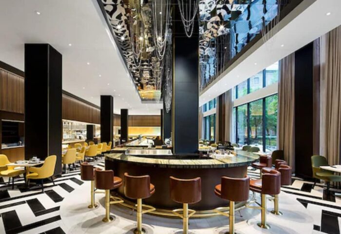 Fairmont The Queen Elizabeth hotel bar interior. Upscale, gay-friendly hotel with stylish decor, seating, and a unique ceiling design.