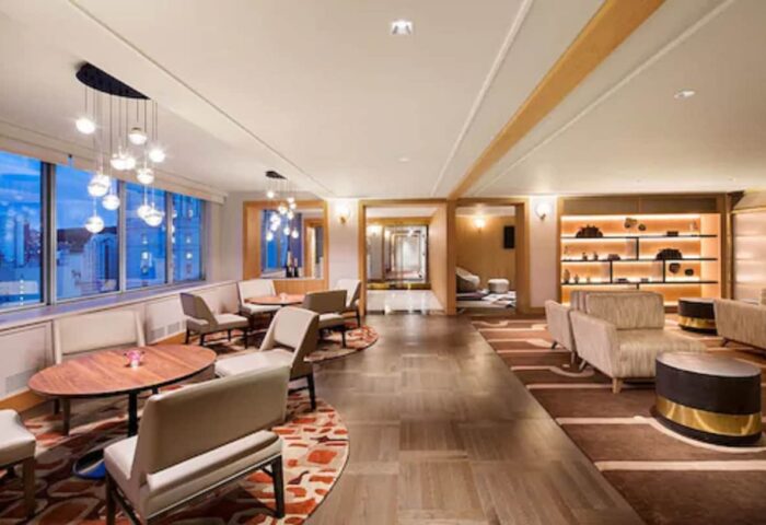 Fairmont The Queen Elizabeth hotel lounge area. Elegant seating, tables, and lighting. A gay-friendly hotel with stylish interior design.