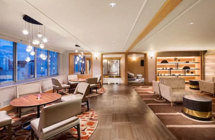 Fairmont The Queen Elizabeth hotel lounge area. Elegant seating, tables, and lighting. A gay-friendly hotel with stylish interior design.