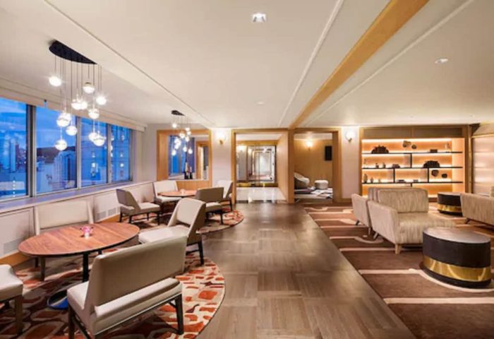 Fairmont The Queen Elizabeth hotel lounge area. Elegant seating, tables, and lighting. A gay-friendly hotel with stylish interior design.