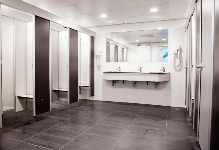 Bathroom at Flying Pigs Downtown Hostel, Amsterdam. Gay-friendly hotel with lockers, sinks, mirror, and tiled floor. Budget travel for gay men.