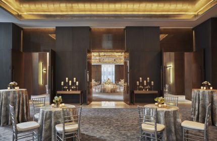 Four Seasons Hotel New York Downtown ballroom. Gay-friendly hotel with elegant event space. Tables with candles and flowers.