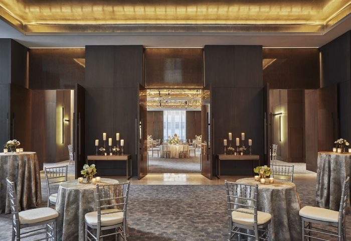 Four Seasons Hotel New York Downtown ballroom. Gay-friendly hotel with elegant event space. Tables with candles and flowers.