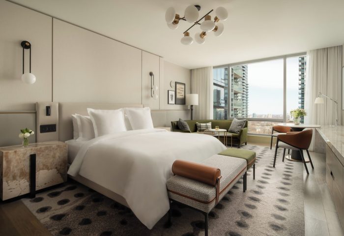 Four Seasons Hotel Toronto at Yorkville: Gay-friendly hotel room with a king-size bed, sitting area, and city view. Luxury gay travel.