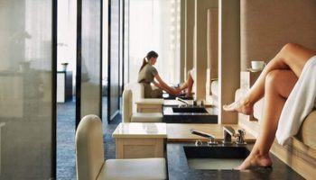Spa at Four Seasons Hotel Toronto at Yorkville. Pedicure stations with women relaxing. Gay-friendly hotel for gay men travel.