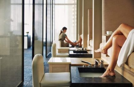 Spa at Four Seasons Hotel Toronto at Yorkville. Pedicure stations with women relaxing. Gay-friendly hotel for gay men travel.