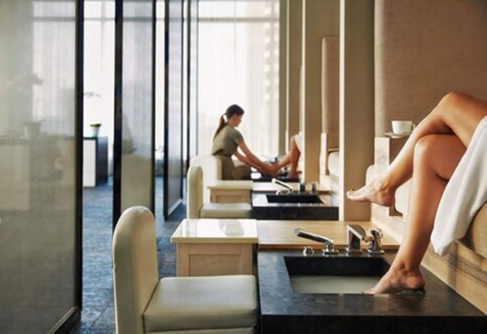 Spa at Four Seasons Hotel Toronto at Yorkville. Pedicure stations with women relaxing. Gay-friendly hotel for gay men travel.