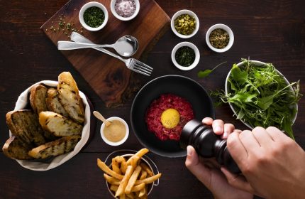 Fine dining at Four Seasons Hotel Toronto. Steak tartare with fries, toast, salad, and condiments. Gay-friendly hotel in Yorkville.
