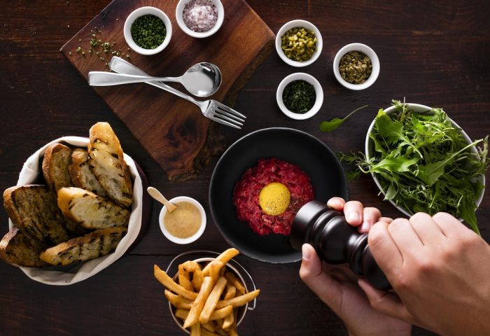 Fine dining at Four Seasons Hotel Toronto. Steak tartare with fries, toast, salad, and condiments. Gay-friendly hotel in Yorkville.