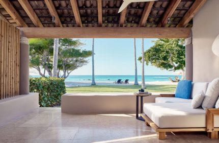 Four Seasons Resort Punta Mita, a gay-friendly hotel. Ocean view from a suite's patio with lounge seating. Beach chairs visible.