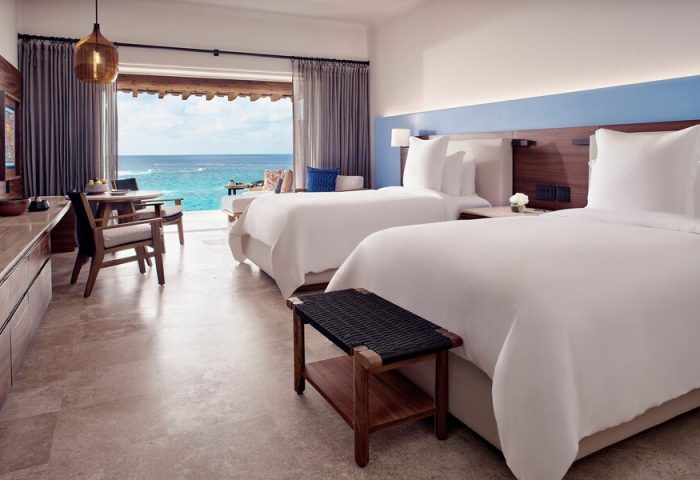 Four Seasons Resort Punta Mita gay-friendly hotel room. Two beds, ocean view, and modern decor. Ideal for gay travelers seeking luxury.