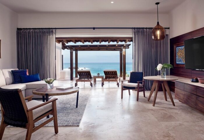 Four Seasons Resort Punta Mita suite. Ocean view from luxury gay-friendly hotel room. Loungers on patio. Upscale travel for gay men.