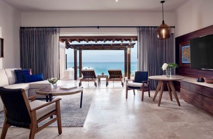 Four Seasons Resort Punta Mita suite. Ocean view from luxury gay-friendly hotel room. Loungers on patio. Upscale travel for gay men.