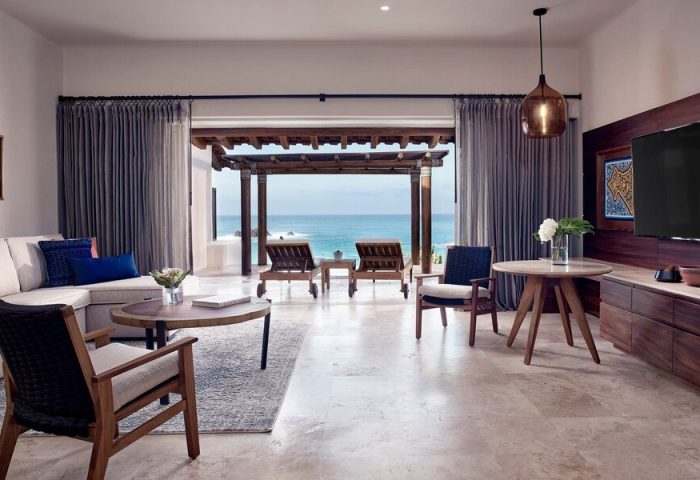 Four Seasons Resort Punta Mita suite. Ocean view from luxury gay-friendly hotel room. Loungers on patio. Upscale travel for gay men.