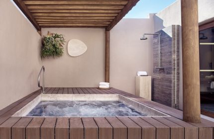Four Seasons Resort Punta Mita gay-friendly hotel: Private outdoor hot tub and shower on a wooden deck, offering luxury and relaxation.
