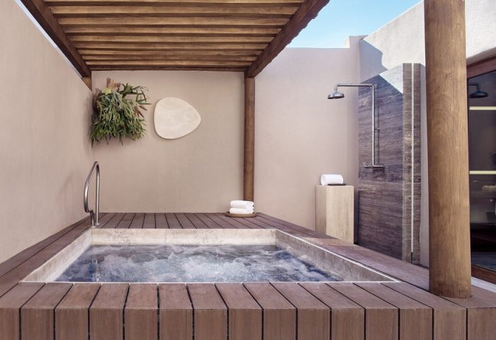 Four Seasons Resort Punta Mita gay-friendly hotel: Private outdoor hot tub and shower on a wooden deck, offering luxury and relaxation.