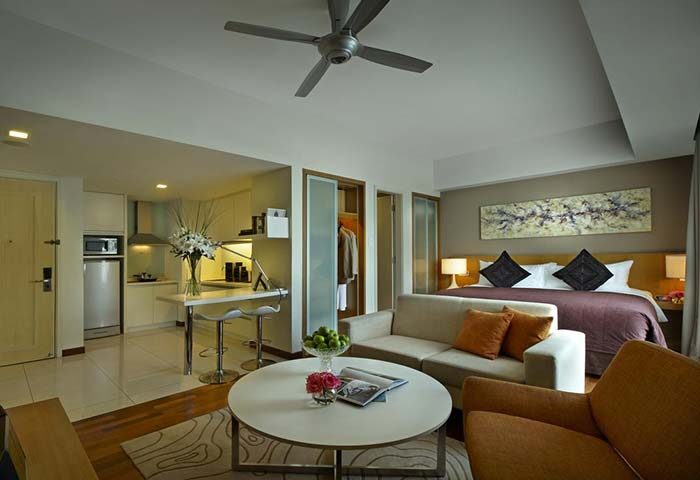 Fraser Place Kuala Lumpur suite interior. Gay-friendly hotel apartment with kitchen, bed, sofa, and modern decor. Ideal for gay travel.