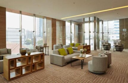 Fraser Residence Menteng Jakarta lobby. Gay-friendly hotel with modern decor, comfortable seating, city view, and computer workstations.