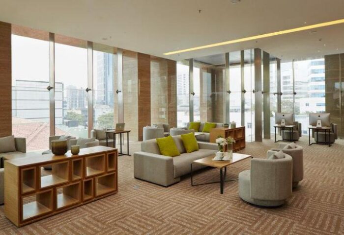 Fraser Residence Menteng Jakarta lobby. Gay-friendly hotel with modern decor, comfortable seating, city view, and computer workstations.