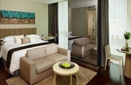 Fraser Residence Menteng Jakarta gay-friendly hotel room. King bed, sofa, & modern decor. Ideal for gay travelers in Jakarta.