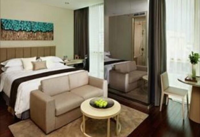 Fraser Residence Menteng Jakarta gay-friendly hotel room. King bed, sofa, & modern decor. Ideal for gay travelers in Jakarta.