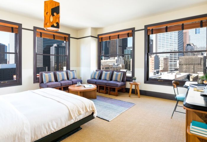 Freehand Los Angeles gay-friendly hotel room. Downtown city views from the windows. Modern design with bed, seating area, and desk.