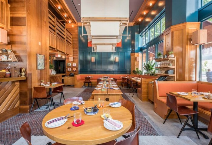 Freehand Los Angeles gay-friendly hotel restaurant. Wood-paneled walls, booths, tables set with plates and glasses. Warm, inviting space.