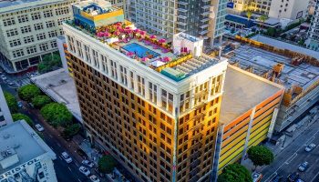 Freehand Los Angeles, a gay-friendly hotel. Rooftop pool and bar with pink umbrellas. Urban hotel in downtown LA.