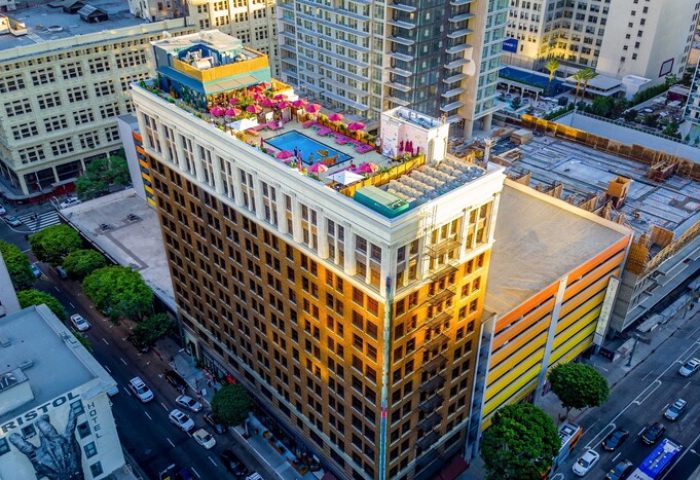 Freehand Los Angeles, a gay-friendly hotel. Rooftop pool and bar with pink umbrellas. Urban hotel in downtown LA.