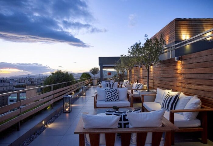 Fresh Hotel's gay-friendly rooftop bar at dusk. Stylish outdoor seating with city views. A perfect spot for gay travelers to relax and socialize.