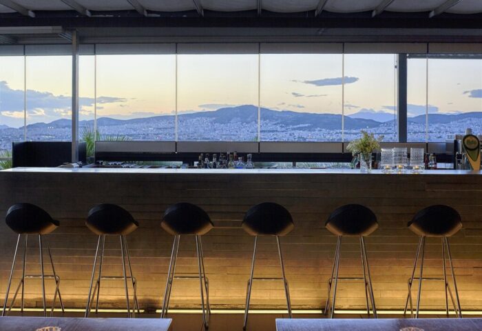 Bar at Fresh Hotel, a gay-friendly hotel. Stools line the bar with a city view. Fresh Hotel is a great option for gay men travelers.