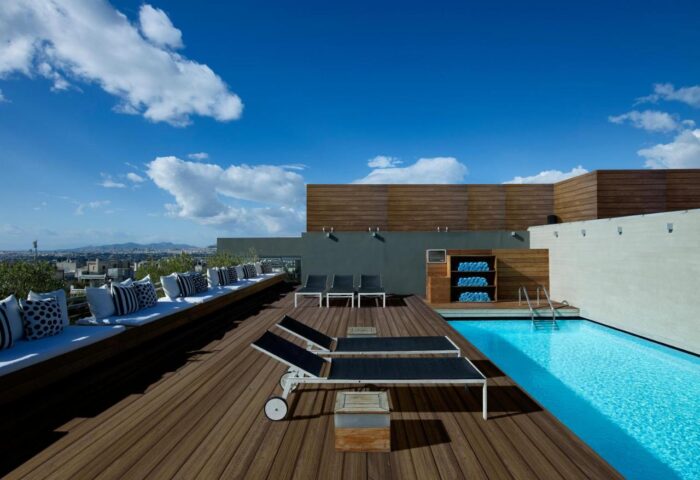 Rooftop pool at Fresh Hotel, a gay-friendly hotel. Deck chairs, seating, and towels are available. Perfect for gay men's travel.