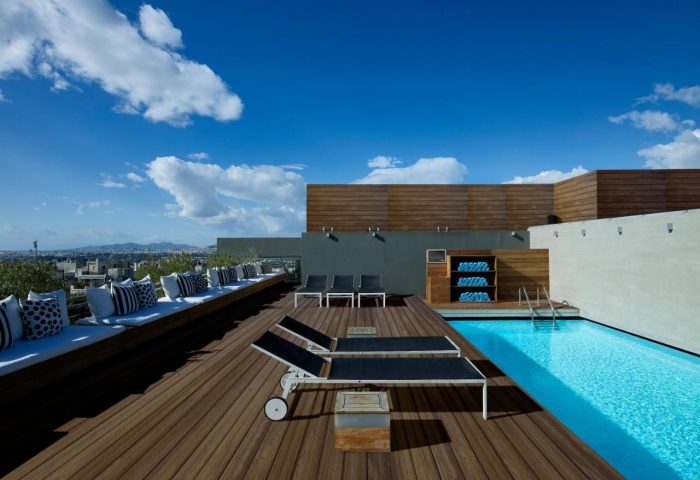 Rooftop pool at Fresh Hotel, a gay-friendly hotel. Deck chairs, seating, and towels are available. Perfect for gay men's travel.