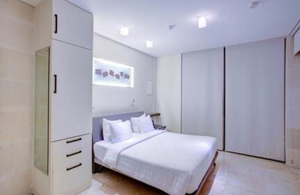 FuramaXclusive Ocean Beach Hotel Seminyak gay-friendly room. Clean, modern design with white linens. Ideal for gay travel in Seminyak, Bali.
