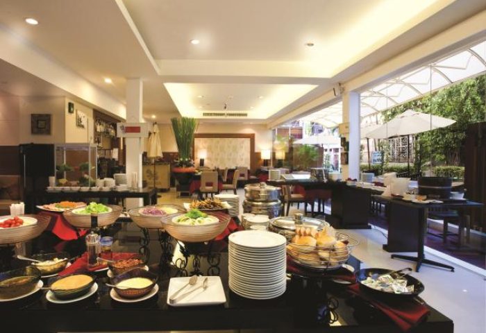 Buffet at FuramaXclusive Sathorn Hotel, Bangkok. Gay-friendly hotel with breakfast bar, salads, bread, and outdoor seating for gay travelers.