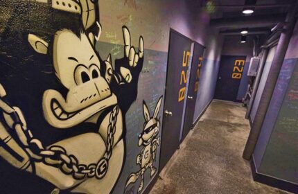 Hallway at G Guesthouse Itaewon in Seoul. Graffiti art of a gorilla and rabbit on the wall. Gay-friendly hotel with unique design elements.