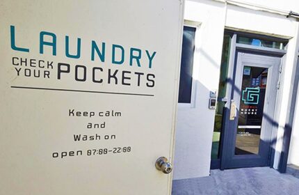Laundry room at G Guesthouse Itaewon in Seoul. Gay-friendly hotel with laundry service. Check your pockets sign. Keep calm and wash on.