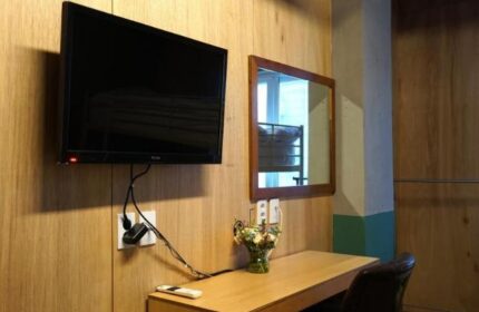 Room at G Guesthouse Itaewon in Seoul. TV, desk, mirror, and chair. Gay-friendly hotel for gay men traveling in South Korea.