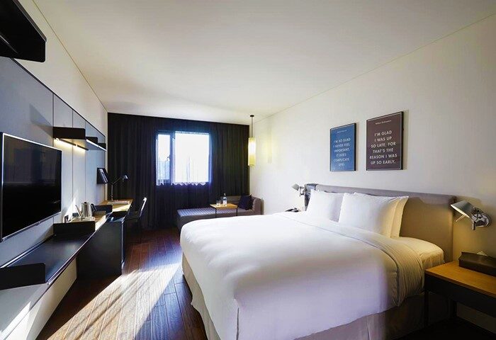GLAD YEOUIDO gay-friendly hotel room. Modern design with a large bed, desk, TV, and seating area. A great choice for gay travelers in Seoul.