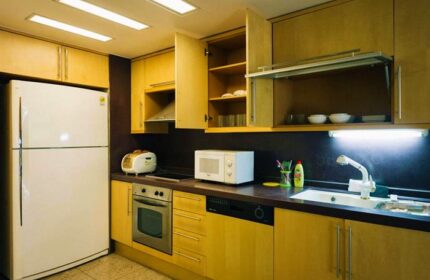 GV Residence gay-friendly hotel kitchen. Features include a refrigerator, oven, microwave, sink, and cabinets. Perfect for gay men travel.