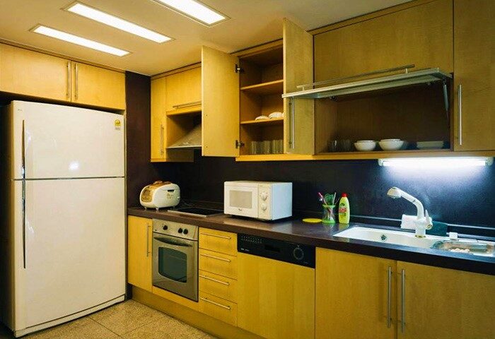 GV Residence gay-friendly hotel kitchen. Features include a refrigerator, oven, microwave, sink, and cabinets. Perfect for gay men travel.