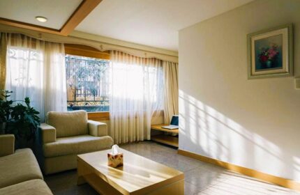 GV Residence, a gay-friendly hotel: Living room with couch, chair, coffee table, and window. Ideal for gay men's travel, a welcoming space.
