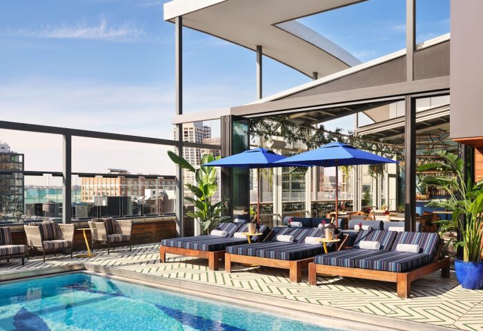 Gansevoort Meatpacking NYC gay-friendly hotel rooftop pool. Loungers, umbrellas, skyline views. Perfect for gay travel in NYC.